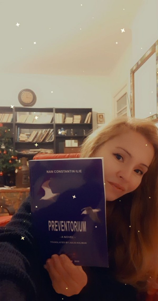 Selfie with book by Nan Constantin Ilie, at the writing studio. Photo by Julia Kalman